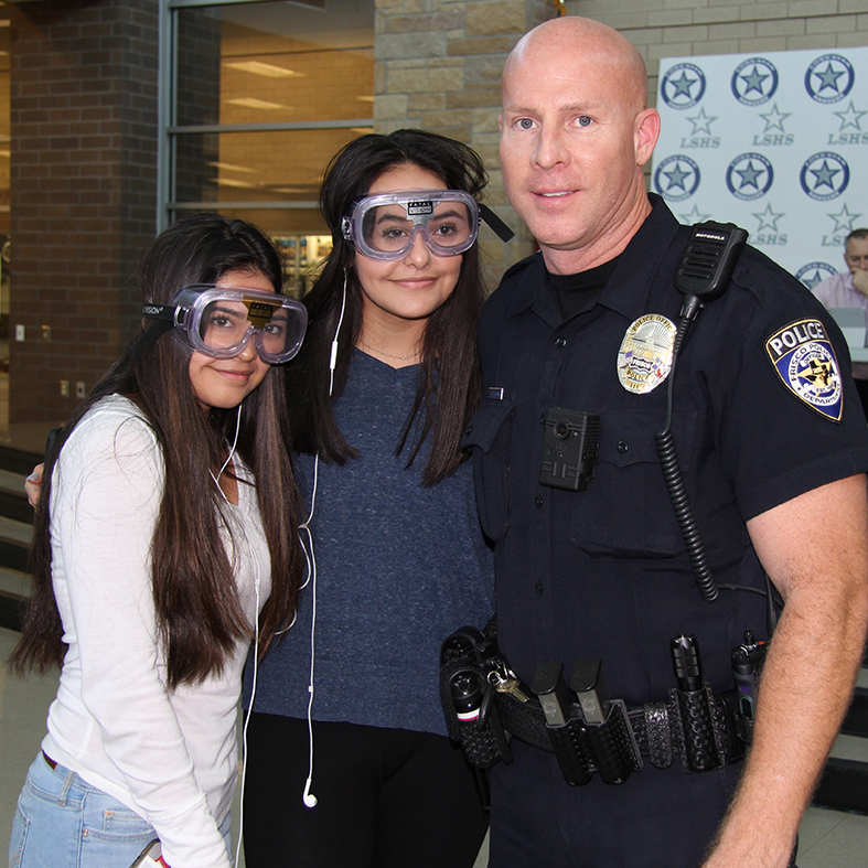 Koski Poses with Students at Lone Star High School